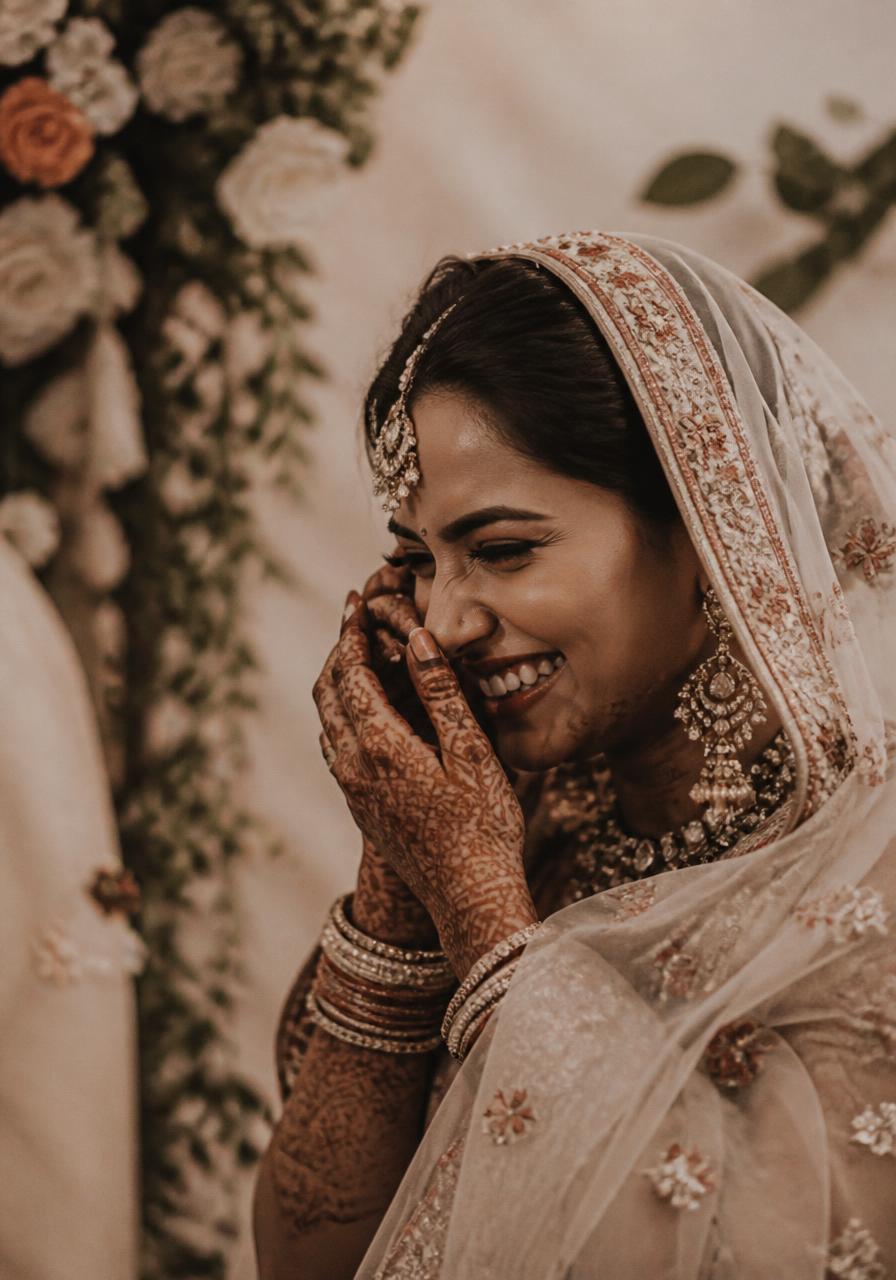 Bride smiling with mehendi-covered hands